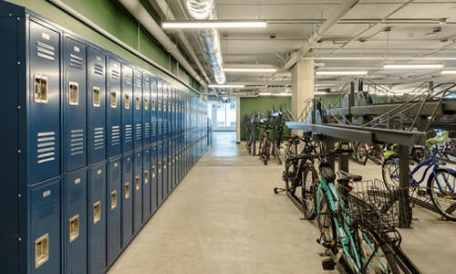 bicycles on racks in bright room with lockers