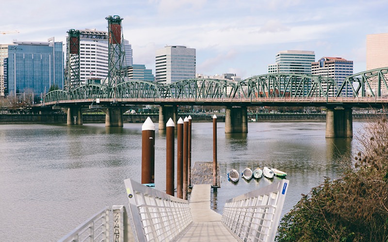 bridge over a river with buildings in the background